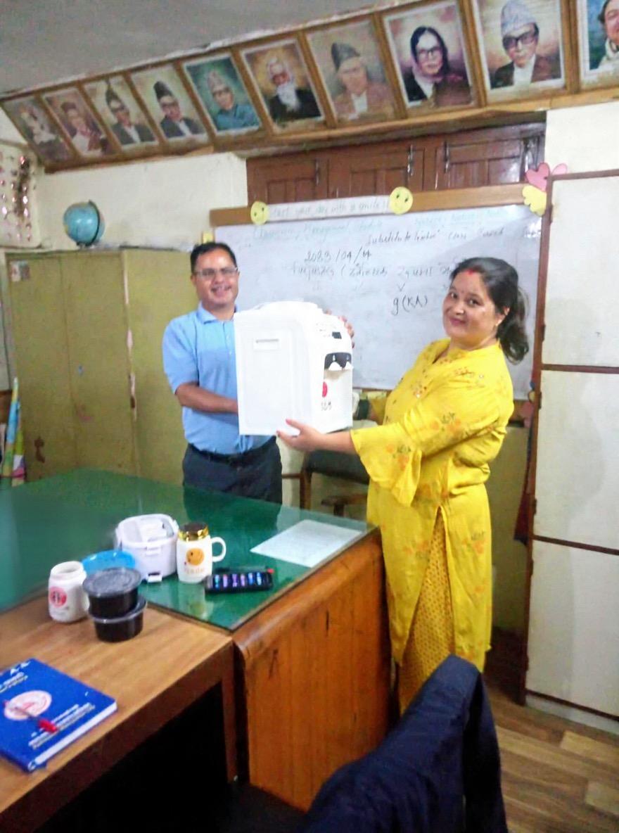 A water filter being presented to a school representative